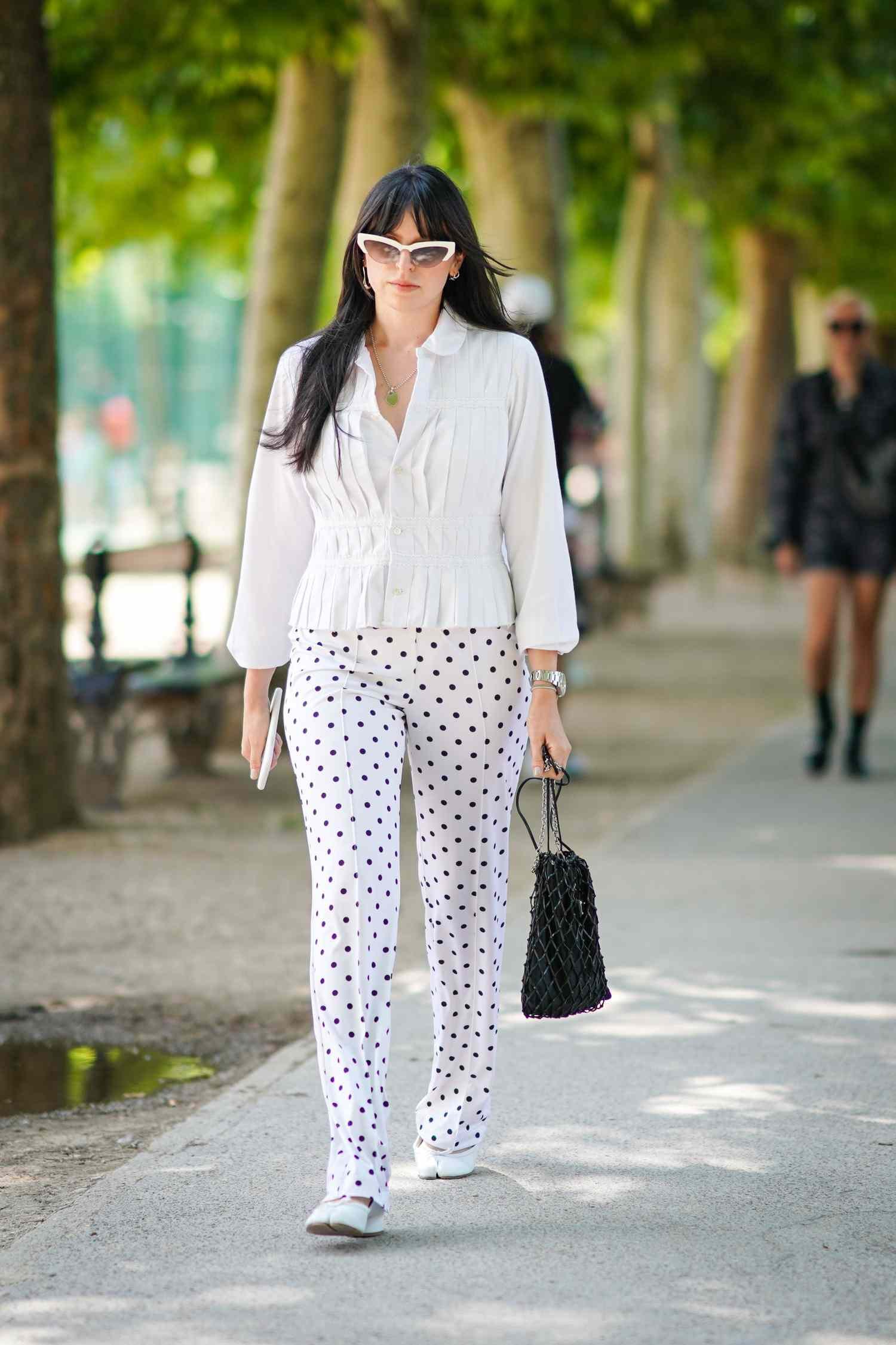 Woman in angstrom unit white top and white knickers with blackness polka dots