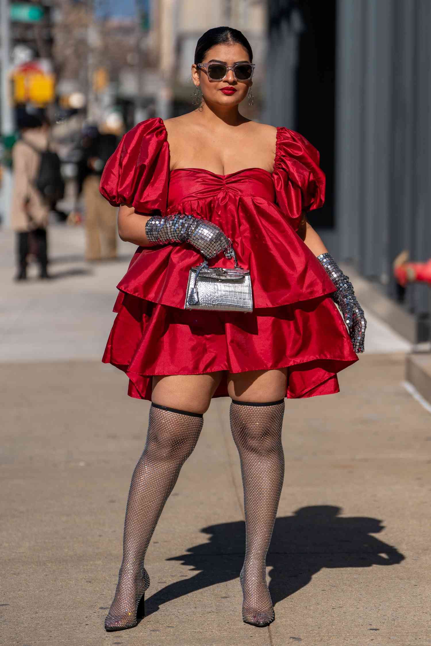 Wearing sheer over-the-knee boots, Rini Jain shows how to wear over-the-knee boots as stocking with angstrom unit red miniskirt dress.