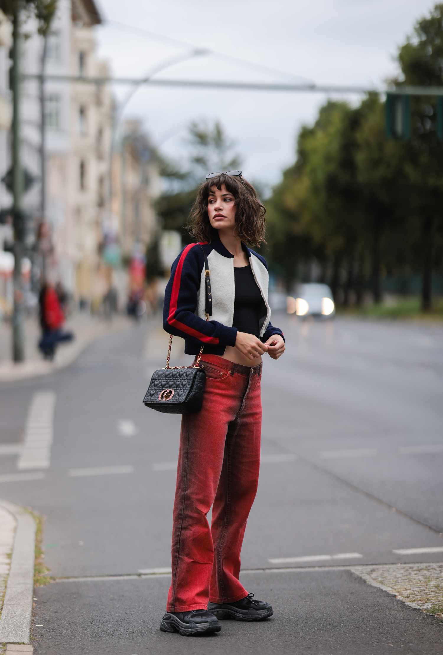 Person wear redness colored denim jeans with angstrom stripe jacket