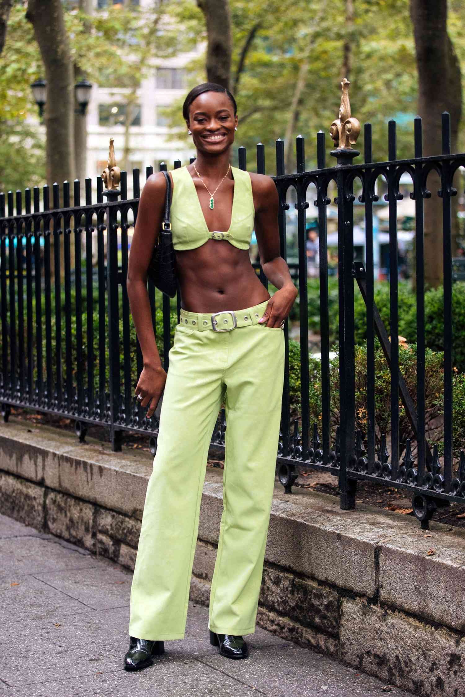 Person wear green colored person denim blue jean and angstrom bra crop top