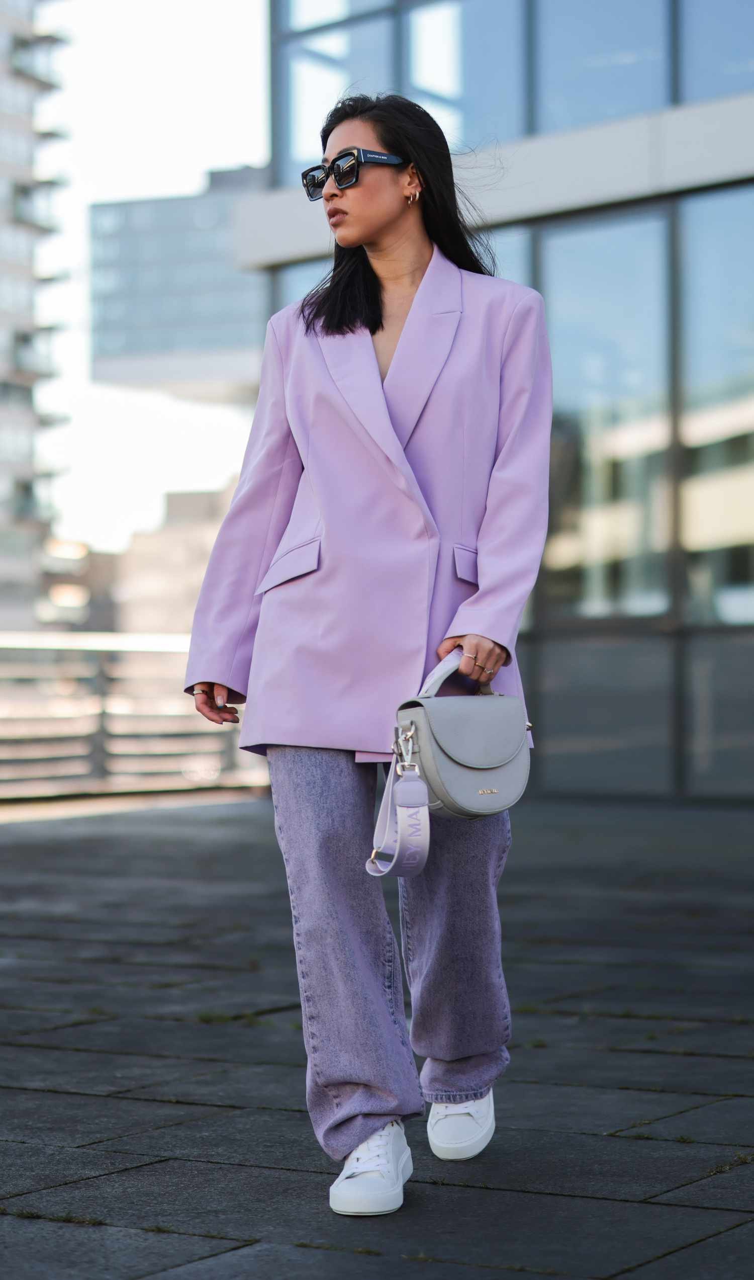 Person wear purple colored jean jeans with an oversized blazer