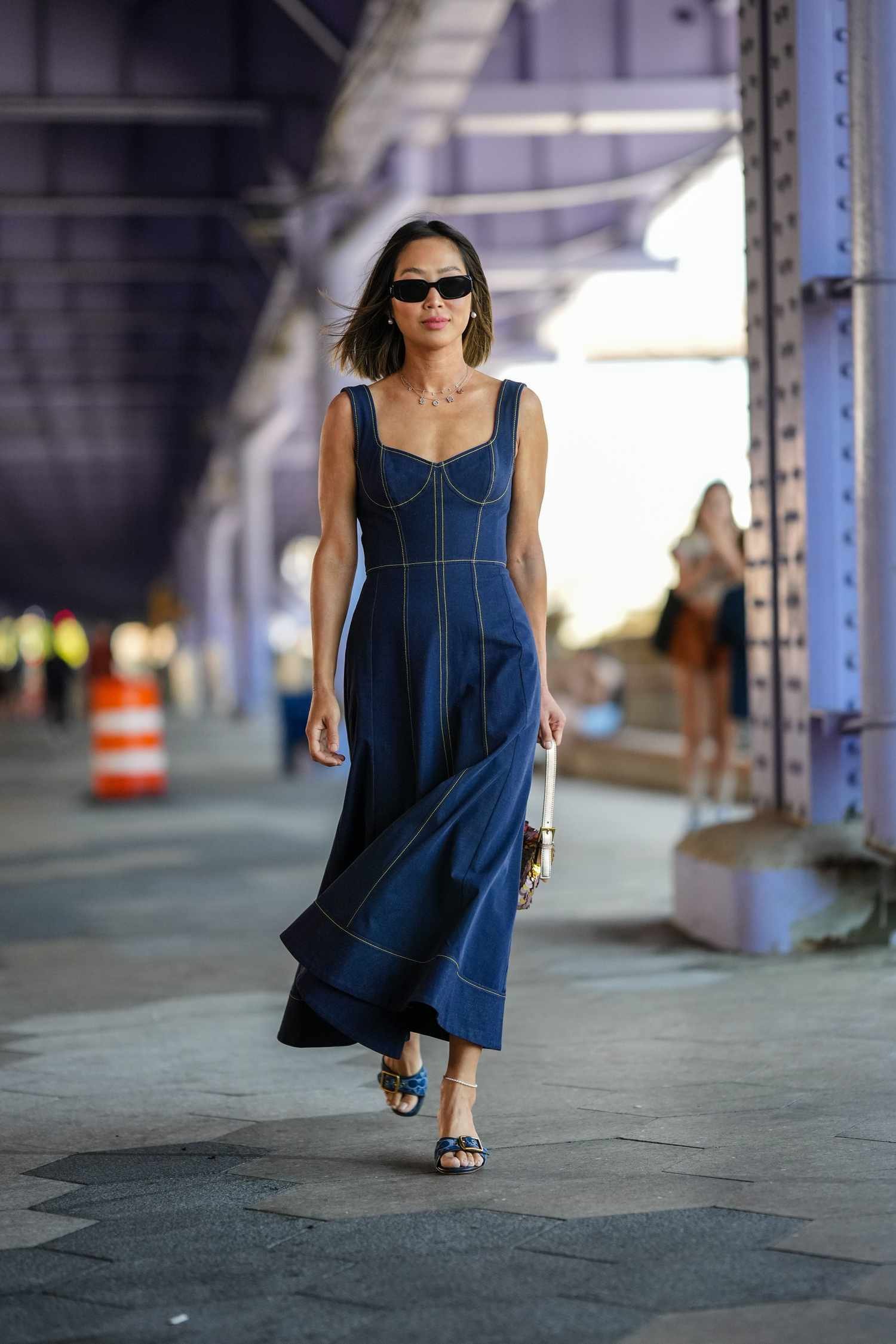 Woman eroding a navy blue blue jean maxi dress