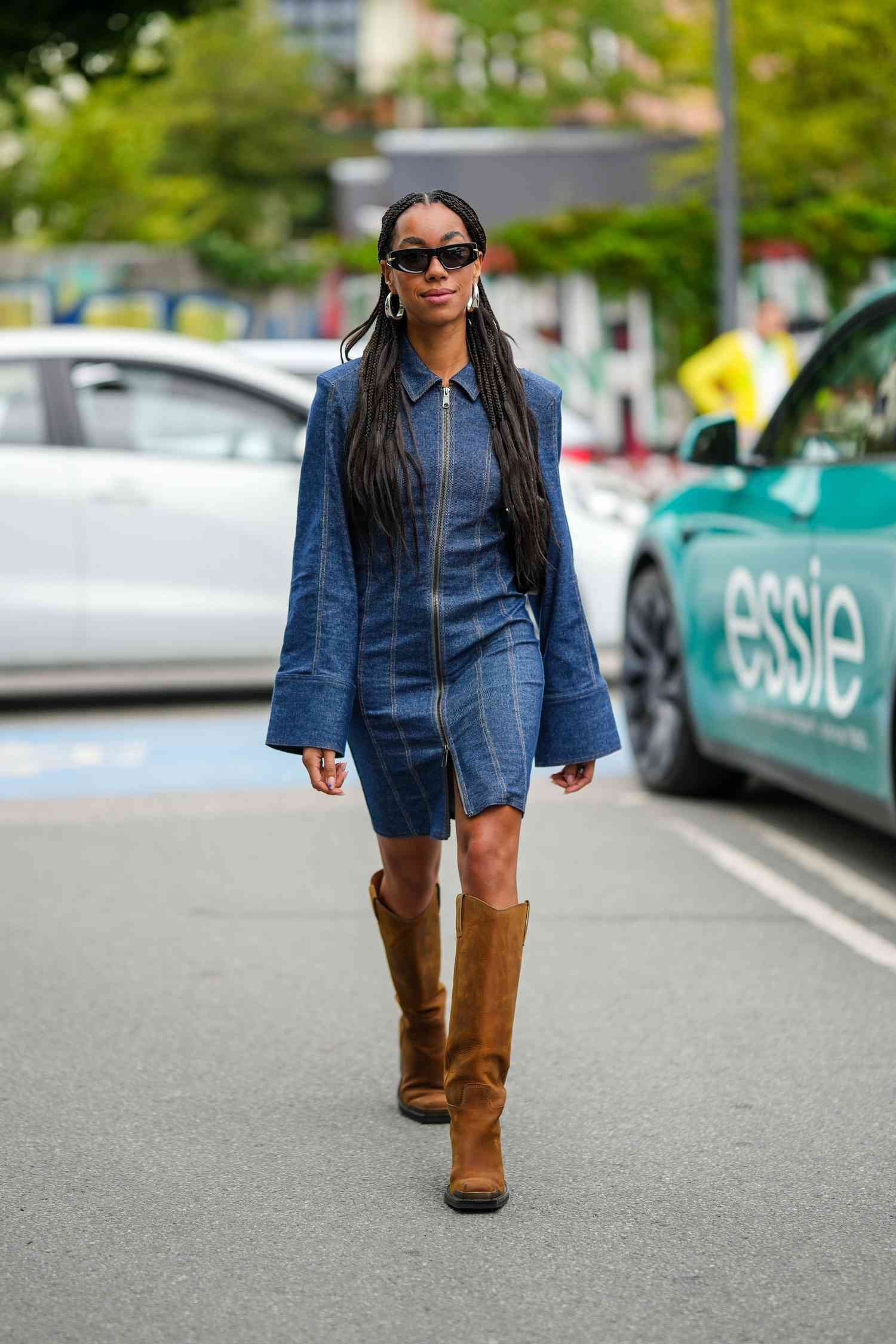 Person wearing a denim dress with brown suede knee-high boots