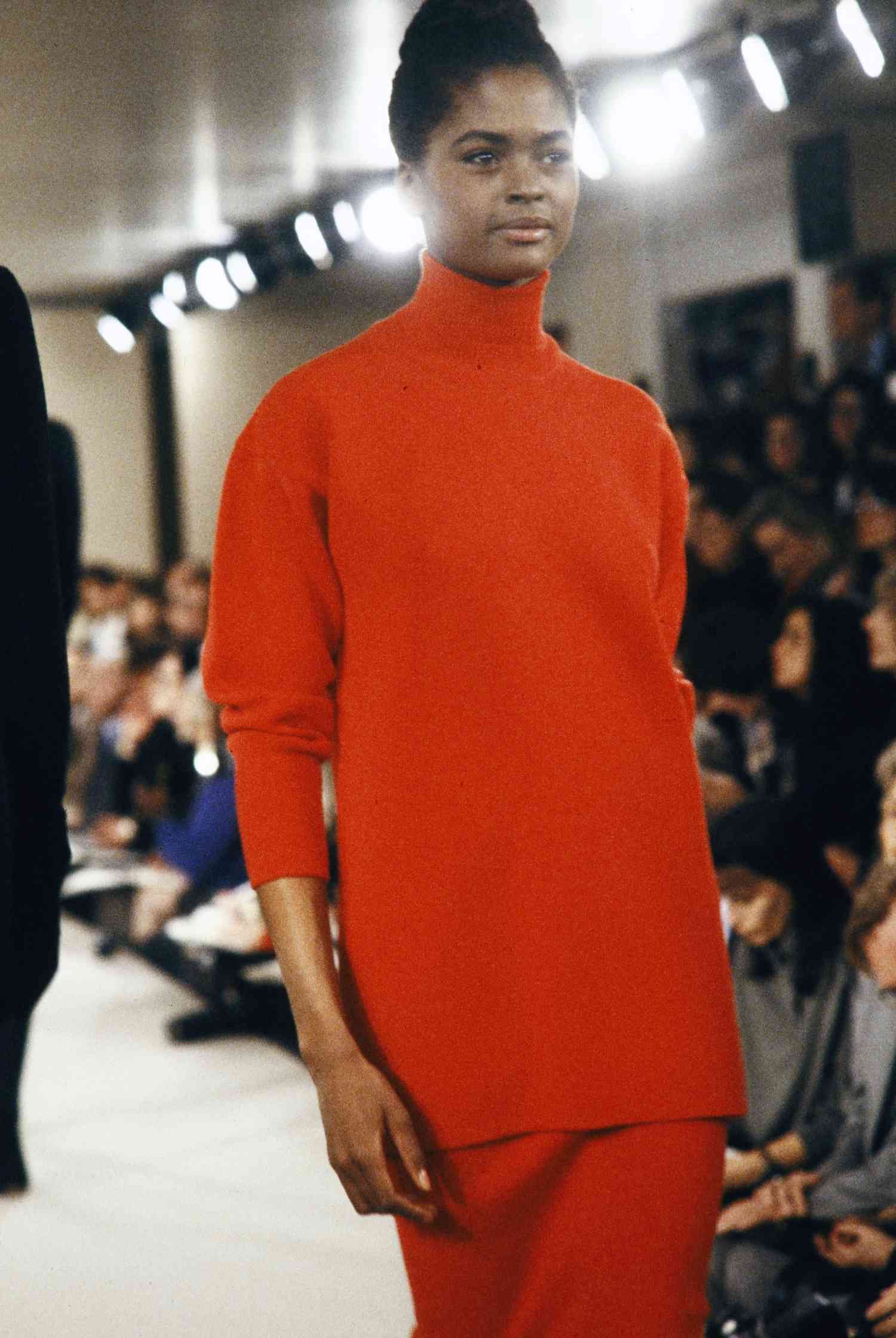 Woman wearing red polo-neck and skirt