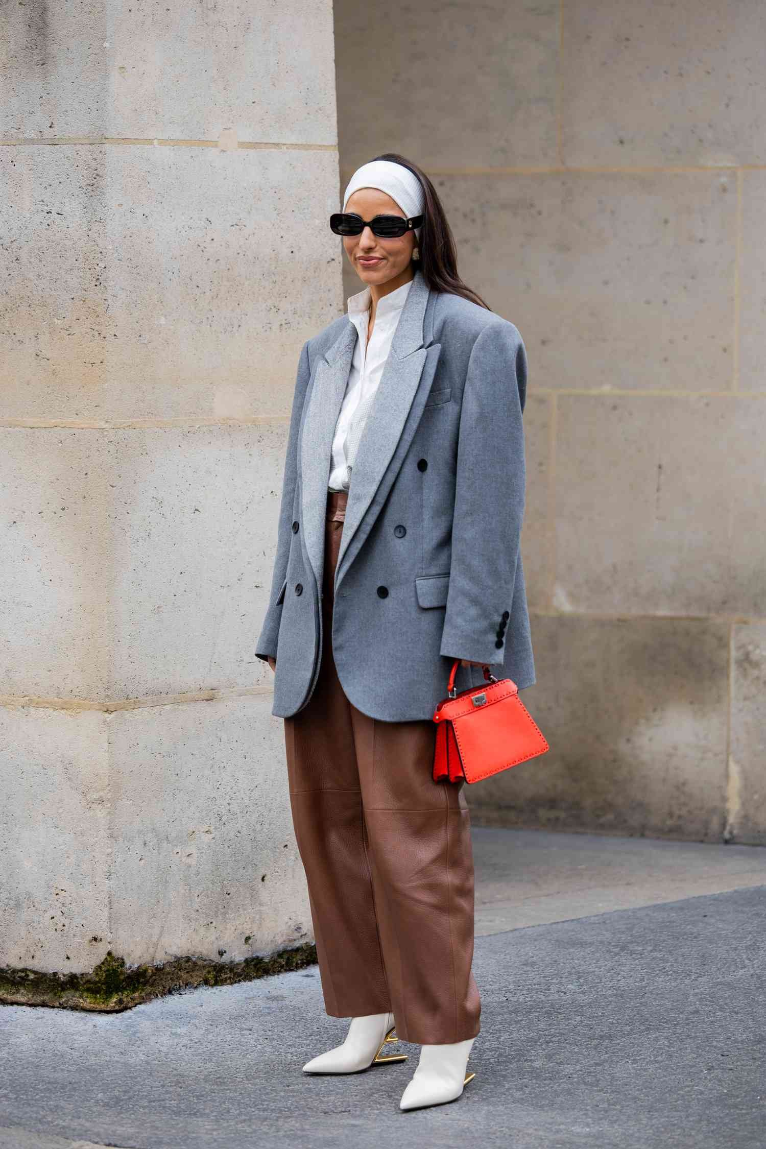 Bettina Looney wear an oversized sport coat and leather pants astatine Paris style hebdomad 2024.