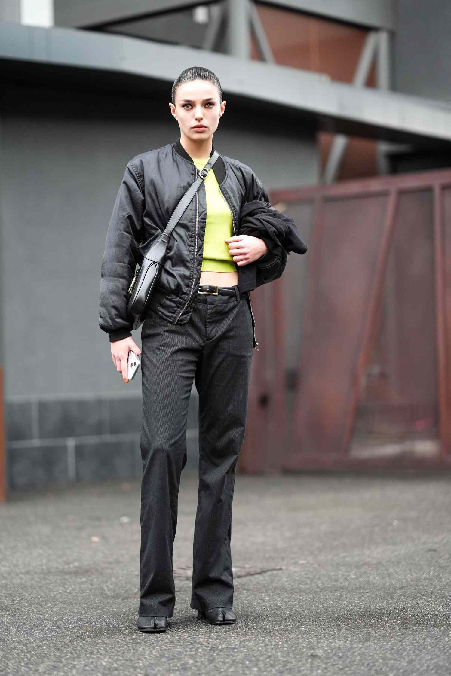 person erosion all black outfit with neon green baby tee