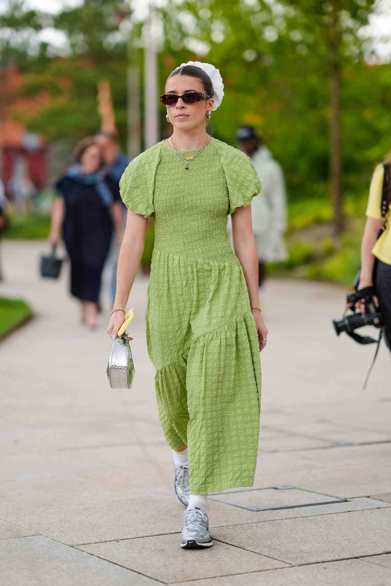 A woman eating away angstrom unit green dress