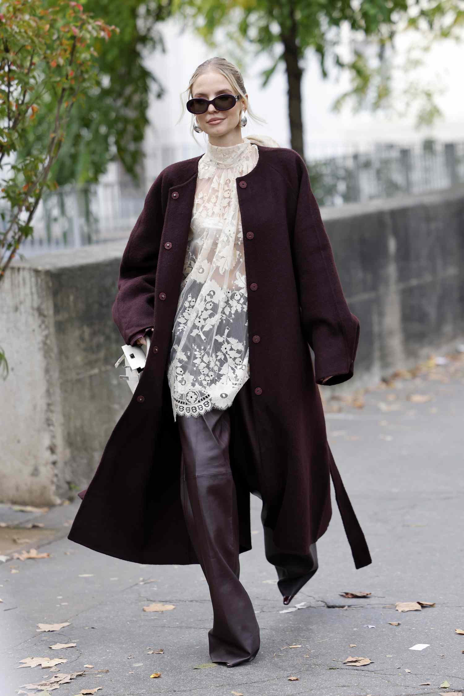 woman wear lacing top and berry colored coat