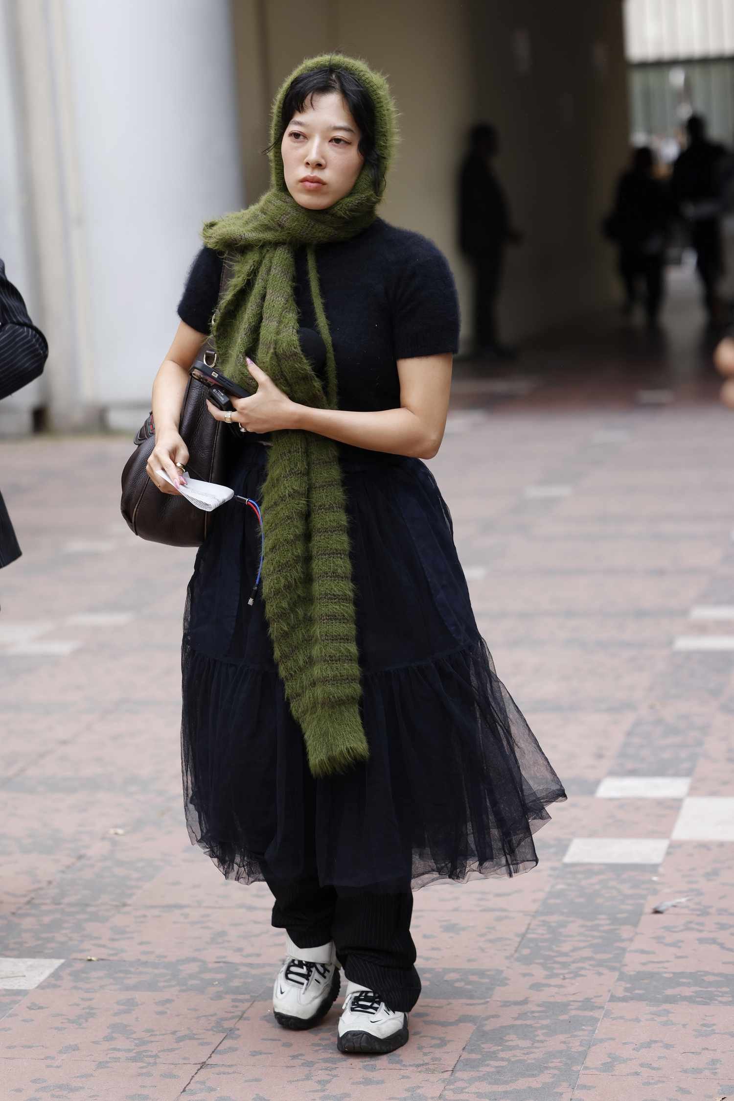 A guest wear blue short sleeves knitted top, blueness tulle skirt, white Nike sneakers, green scarf, outside Sacai, during Womenswear Spring/Summer 2025 atomic number 33 part of Paris Fashion Week