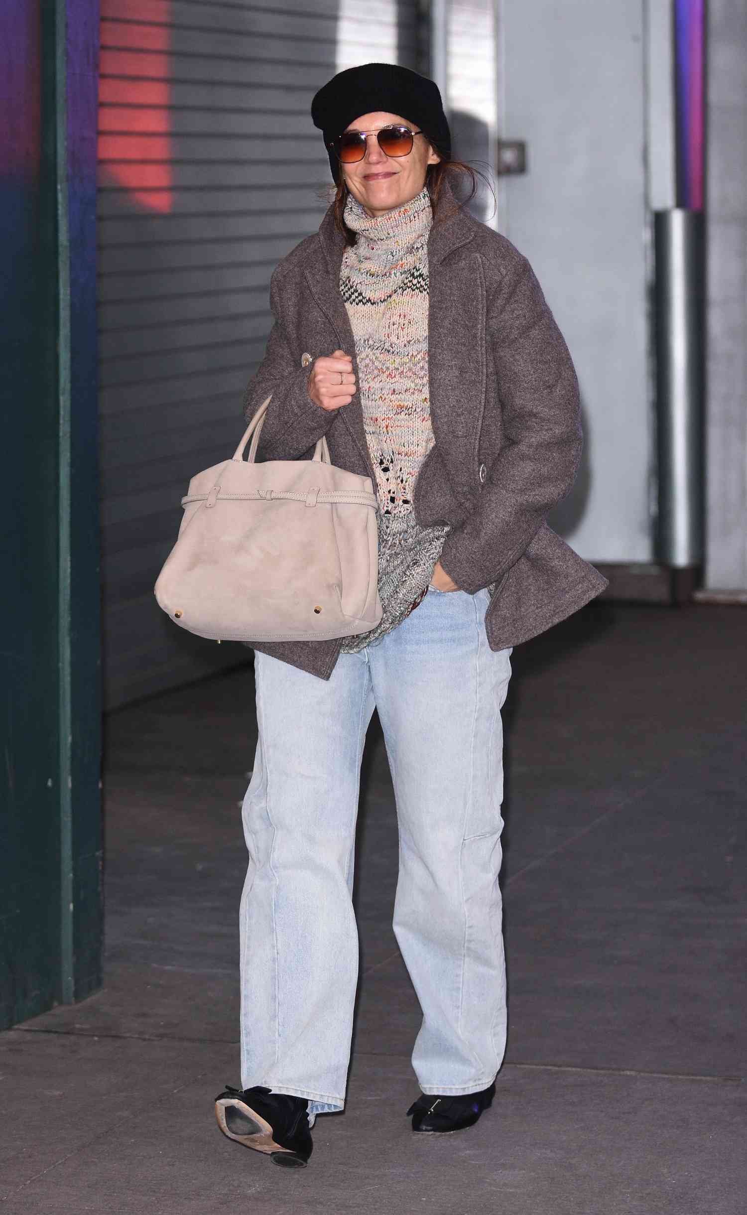 Katie Holmes wearing turtle and wool coat with hat