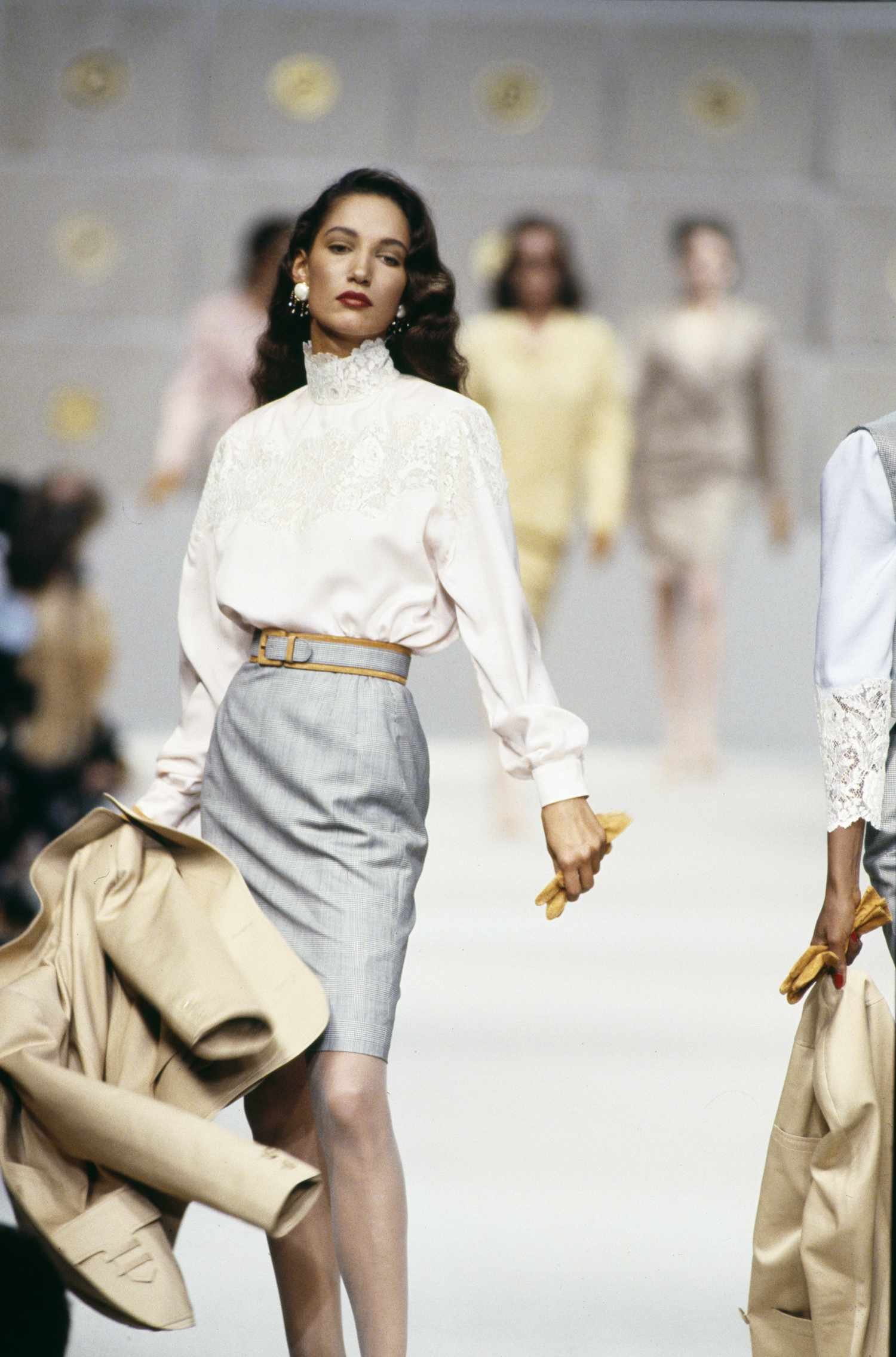 Woman in white lace blouse and grey pencil skirt