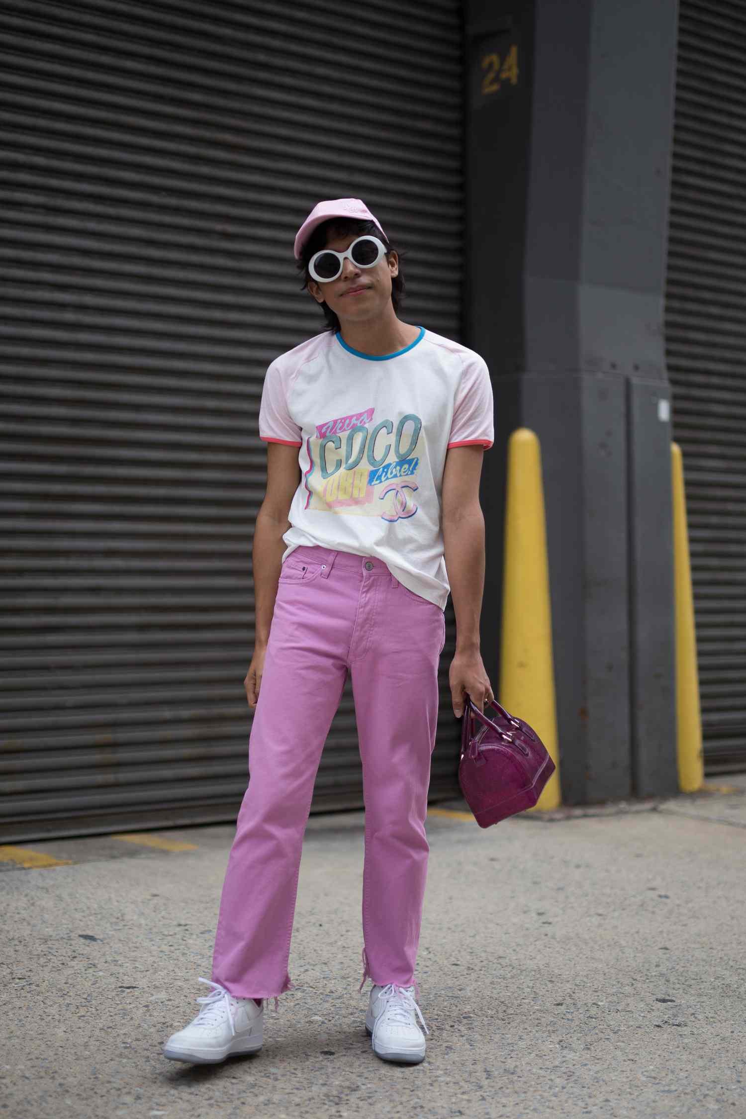 A person wear pink colored blue jean and a graphic tee