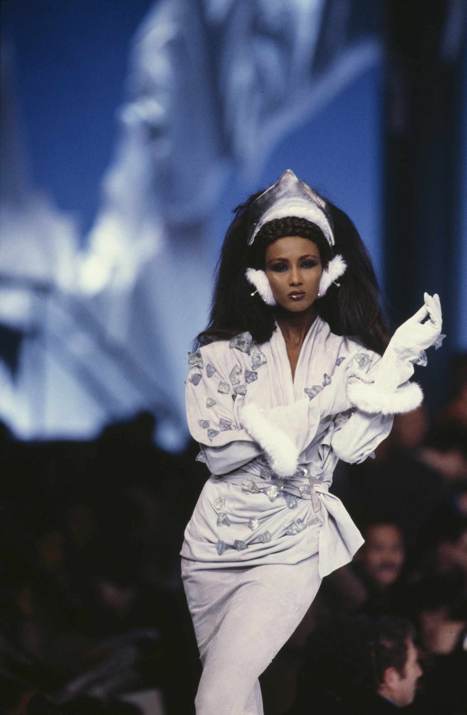 Model wearing white gown and gloves