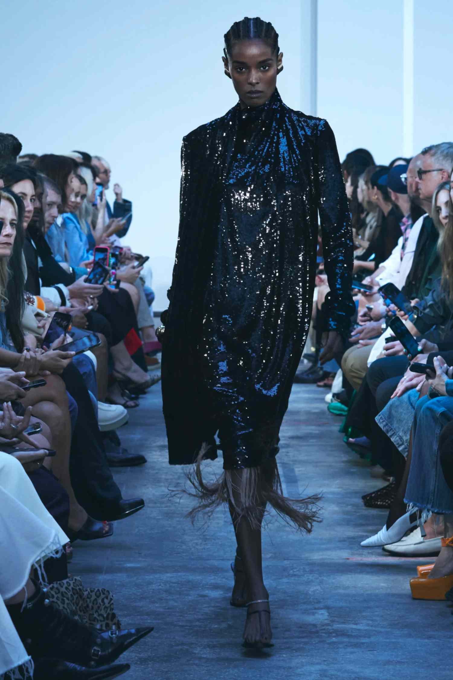 Model wears a black sparkly dress on the Khaite fashion show runway