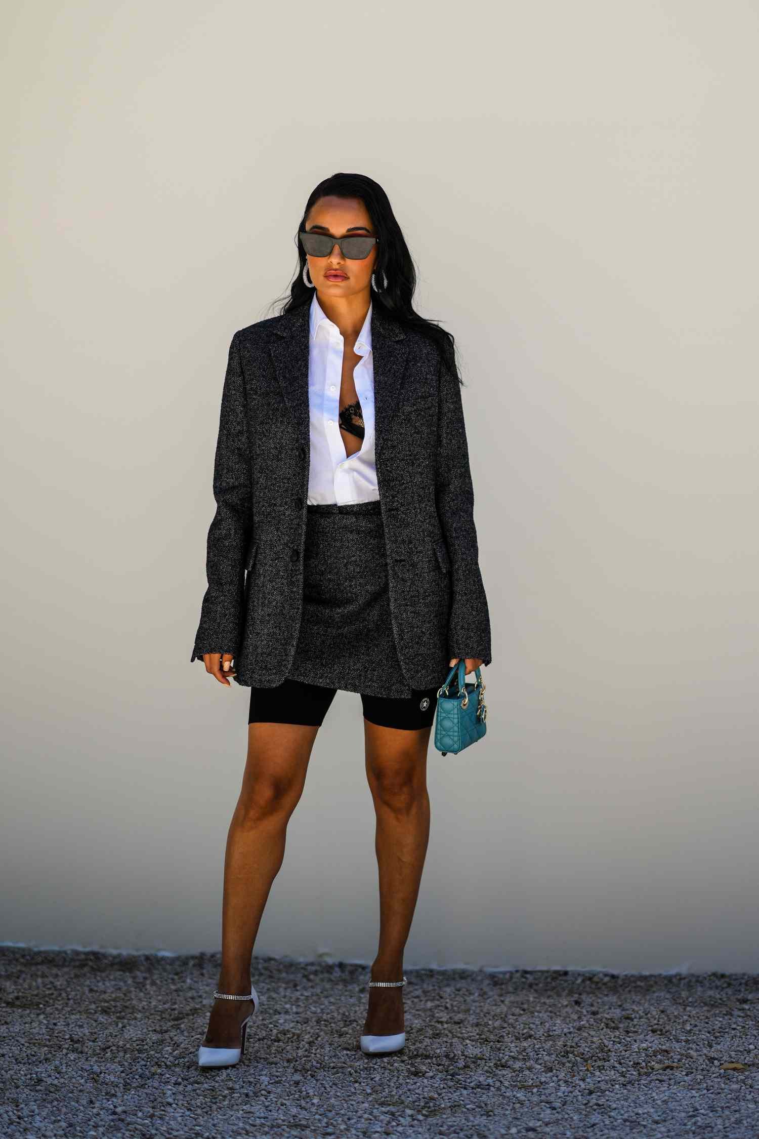 A woman wear bike shorts under a skirt suit